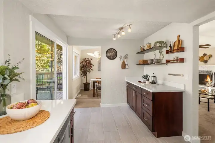 Newer cabinets, quartz countertops and plenty of prep and storage space.  Sliding glass doors open to a large deck overlooking the rear yard.