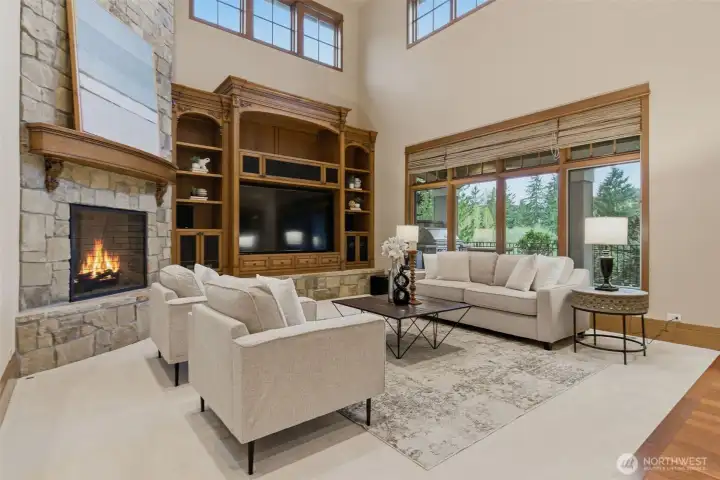 The family room is light and bright with large windows, and a full floor to ceiling striking fireplace. There's a 95" TV that will convey with the home.