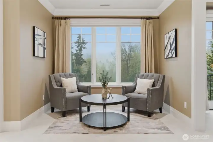 There's a separate sitting area in the primary suite between the bedroom and the bathroom. It's a wonderful place to sit and relax at the end of the day