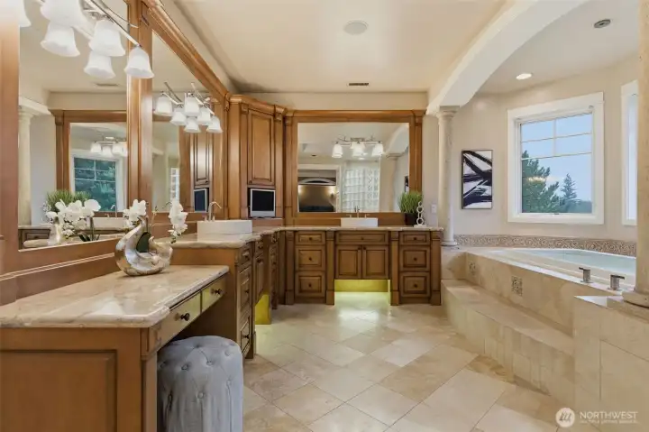 The primary bathroom will surprise and delight in multiple ways. From heated floors, custom cabinetry, a large walk-in shower, and a huge walk-in closet