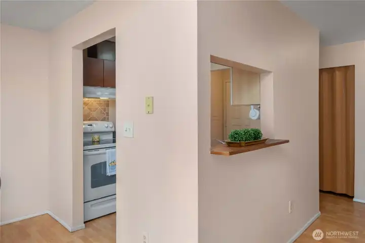 Kitchen has window into Living Room