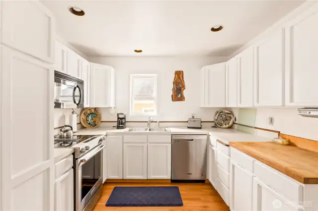 Bright and cheery kitchen it outfitted with stainless appliances and ample storage space.