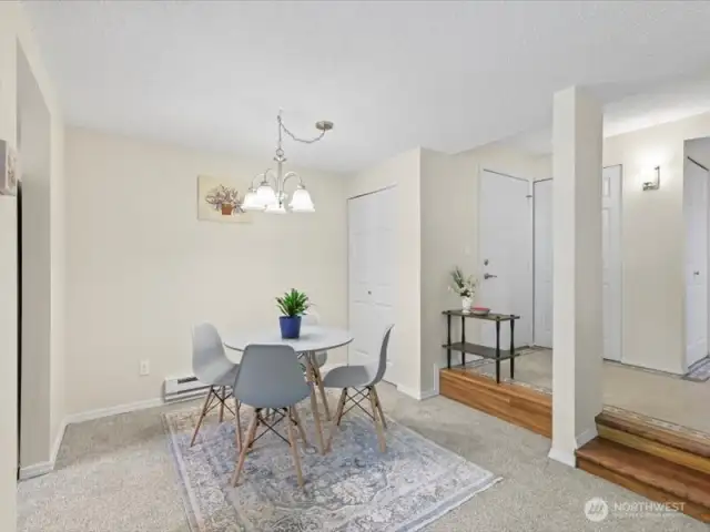 Standing in living area overlooking dining room and entry way. Both light fixtures replaced. You can also see storage closet behind table to use as pantry, etc.