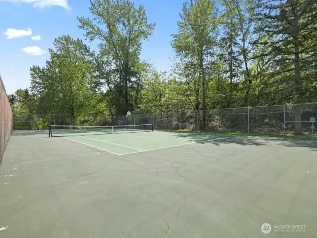 Tennis court along w/ a basketball hoop!