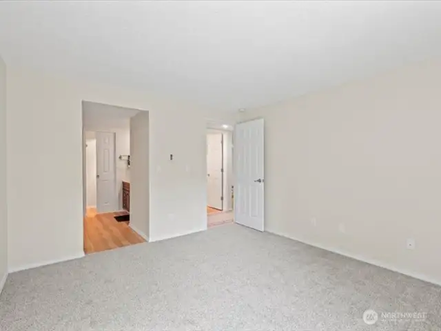 Primary bedroom with bathroom access on left. Six panel pocket door replaced along with all other door.