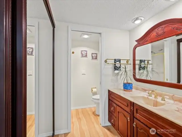 Close up view of primary bathroom. Pocket door separating the shower and toilet.