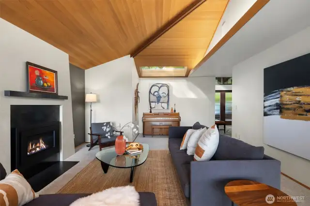 The sky-lit living room has great flow from both the foyer & dining room.