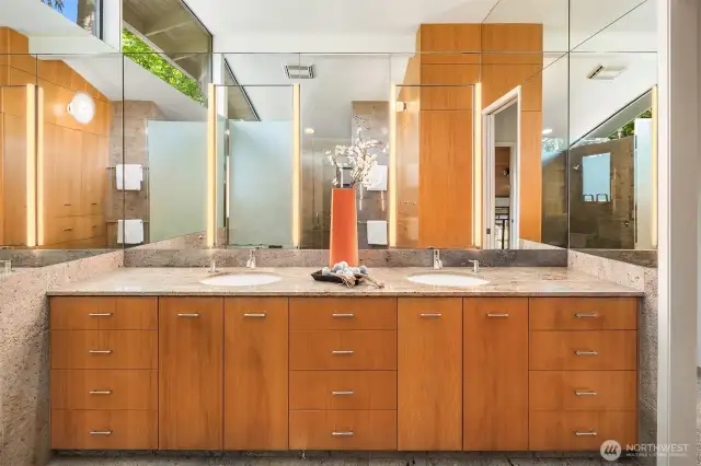 Massive dual vanity topped with slab granite.