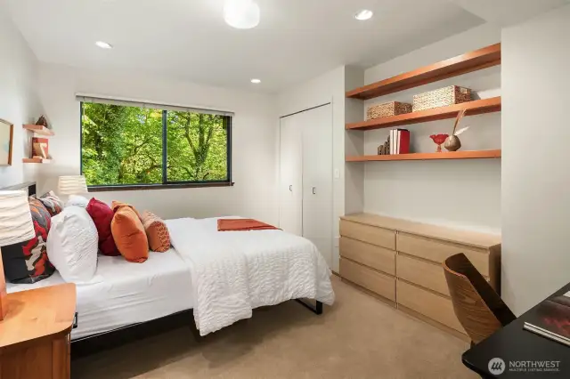 Three bedrooms are on the lower level, including this one with custom built-ins.