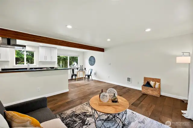 A cozy spot to unwind—enjoy open sightlines from the living room to the kitchen and dining space, perfect for everyday comfort or entertaining guests.