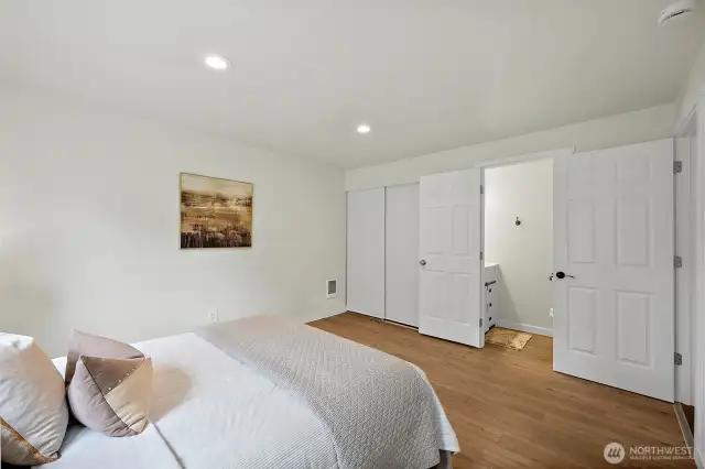 Bright and calming bedroom retreat featuring double closet doors and a convenient ensuite half bath.