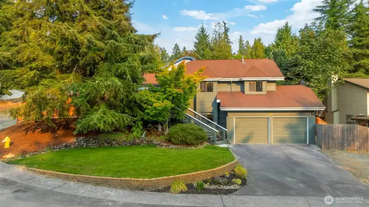 Front view of the house with trees and new sod