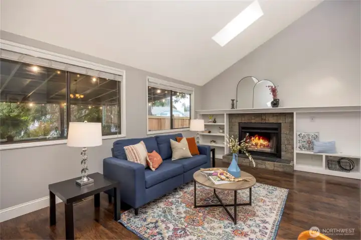 Living room with wood burning fire place and built ins.