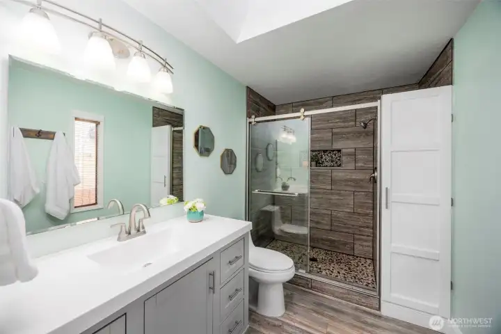 Primary bathroom. Recently remodeled. Has a laundry shoot in the white cubard.