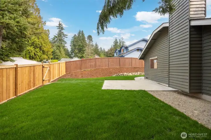Side yard with new sod & NEW fence.