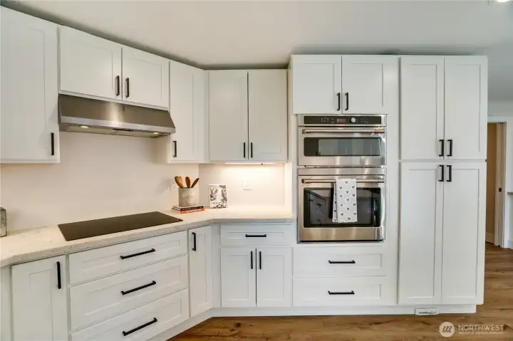 The extensive new, soft-close cabinets include tall pantry cupboards, and a pull-out spice rack. Above the oven there's a multi-function/combination microwave which offers oven function.