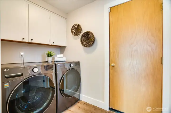 The laundry room features this new washer and dryer set. Take the door from the laundry room into the attached, 2-car garage.
