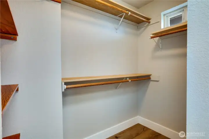 A door in the private bath opens to the primary suite's walk-in closet.