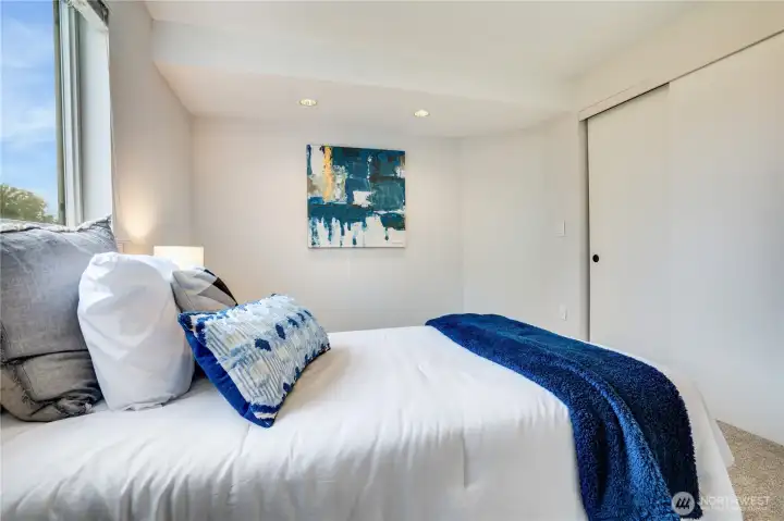 Find this updated 2nd bedroom overlooking the back yard. Sliding doors cover a good-sized closet space.