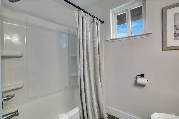 The full bath has new lighting, paint, and a new shower head in addition to recent updates by the previous homeowners.