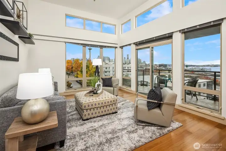 Two walls of windows, with 12 foot ceilings, transom windows usher in more light.  Corner unit offers views from the city and the Needle, to the   Olympics and the Sound.