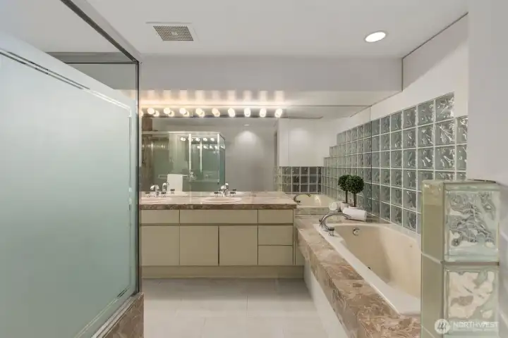 Double sinks, a jetted tub, and a large walk in shower.
