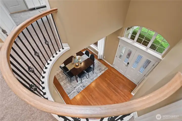 View from 2nd floor landing down to foyer and dining area