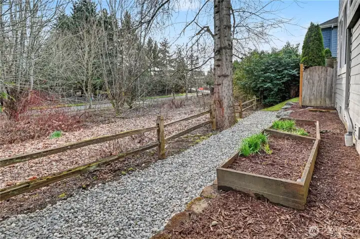 Side yard with planting beds next to protected area