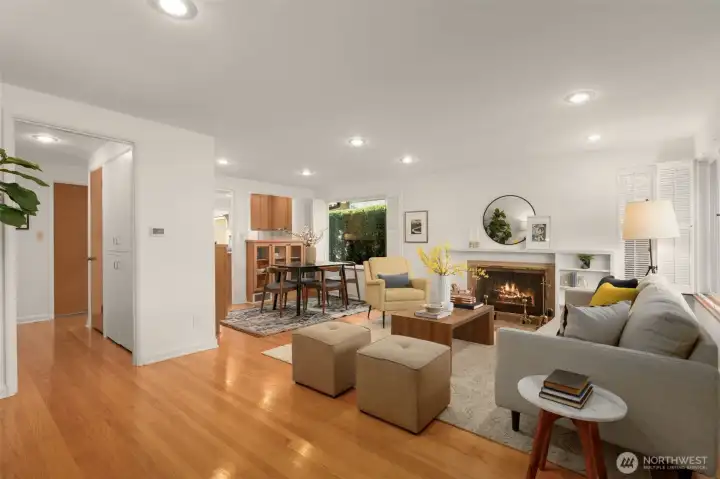 Cozy living room with shutter window treatments and wood burning fireplace.