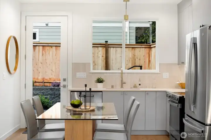 Kitchen has easy access to level backyard patio. Perfect for BBQ's and outdoor seating in the summer months.