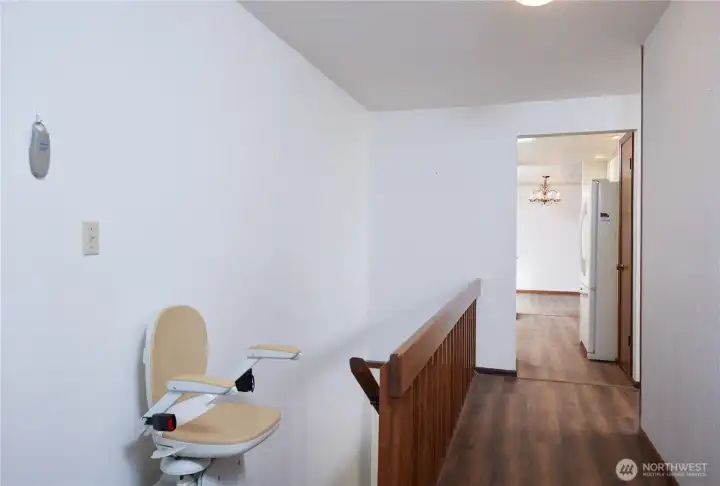 stairs to basement with chair lift