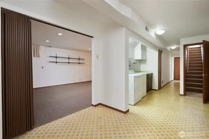 laundry area showing hall to basement bedrooms