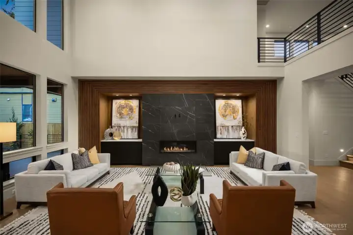 Modern gas fireplace with extensive millwork in this open to above space