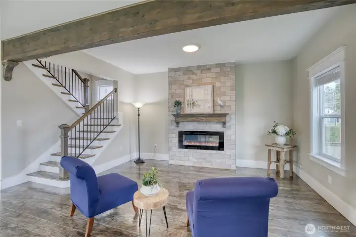Large living room with electric fireplace and wood mantel