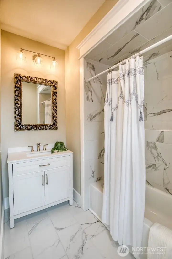 Primary en-suite with tile floors and matching shower