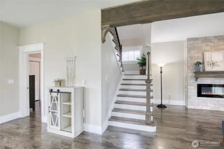 Beautiful staircase to second story with stain glass windows