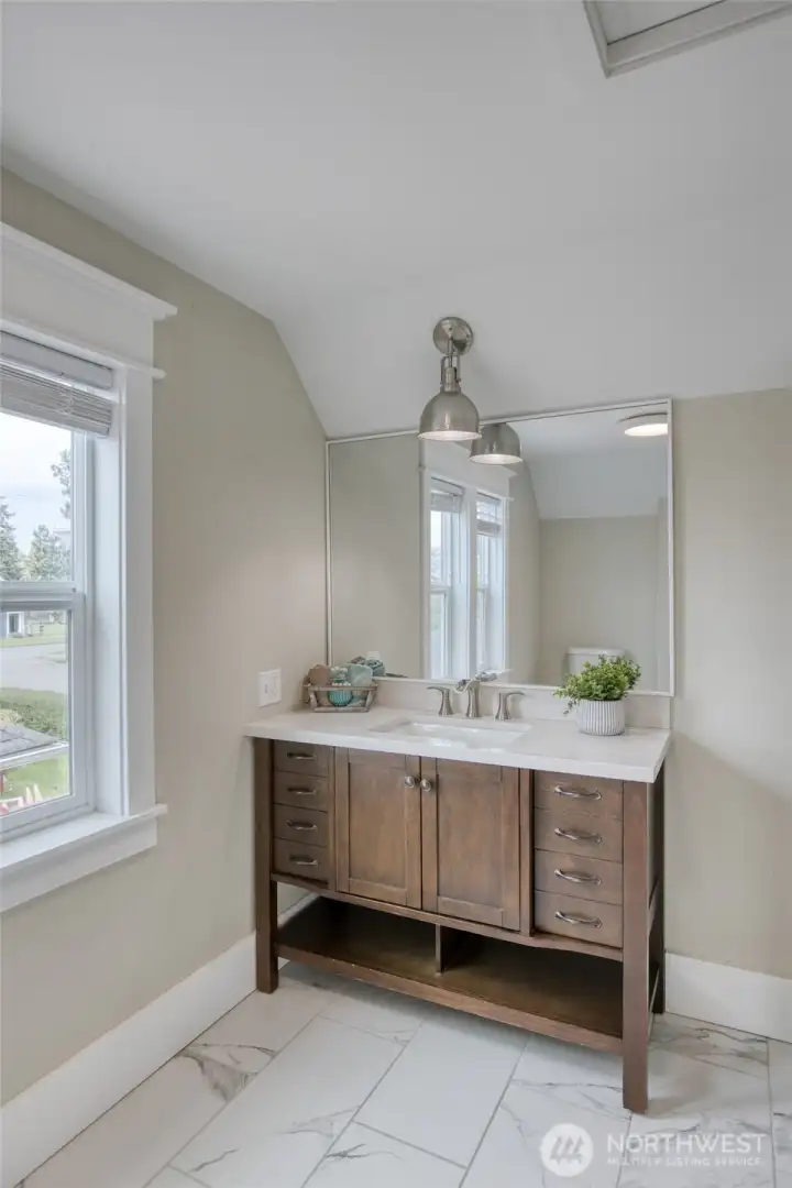 Vanity with designer light fixture in guest bathroom