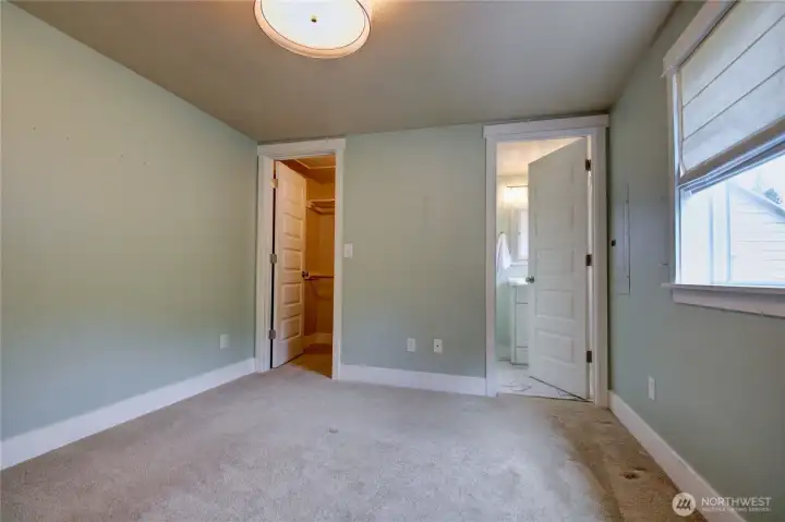 Primary bedroom with walk-in closet and 1/2 bathroom.