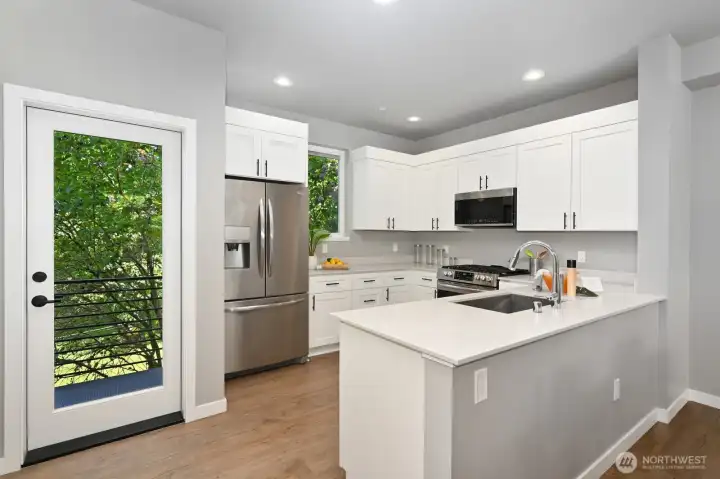 Tons of counter space and cabinets in this roomy kitchen; including room for the BBQ on the deck.
