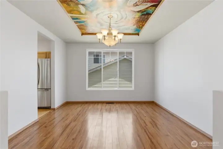 This generously sized dining room features a one of a kind professional artist's painting on the ceiling. Reminiscent of European homes it is intentionally placed such that the painting can be removed if a new owner would prefer.