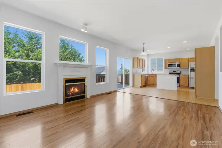 Large windows fill these rooms with natural light and connect the interior with the exterior space. Evenings cozy up with a natural gas fireplace surrounded by a unique decorative mantel.
