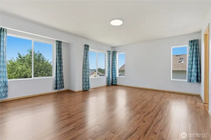 The natural light filling this home is especially evident in this spacious primary suite.