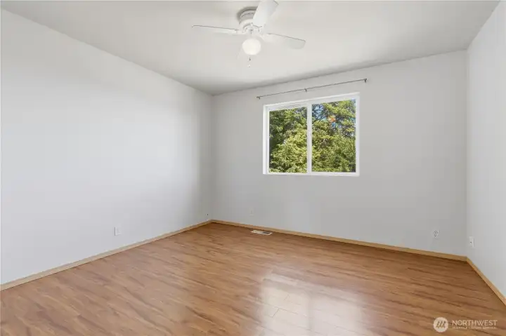 Bedroom #2. The bedrooms all feature easy care flooring, large windows and ceiling fans.