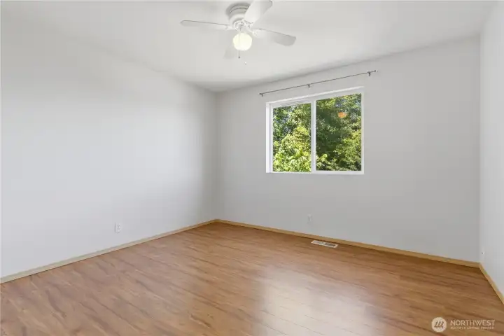 Bedroom #3. You will see only slight differences in shape and closet layout between the auxiliary bedrooms still maintaining a large window, great floors and ceiling fans for comfort.
