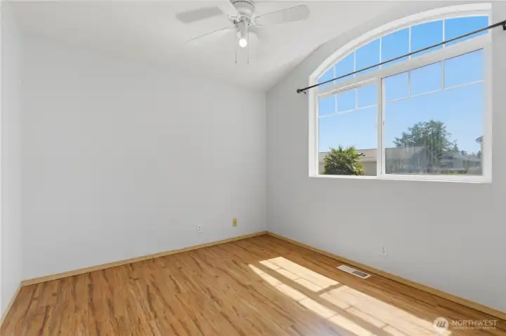 Bedroom #4. This bedroom features a charming arched window.
