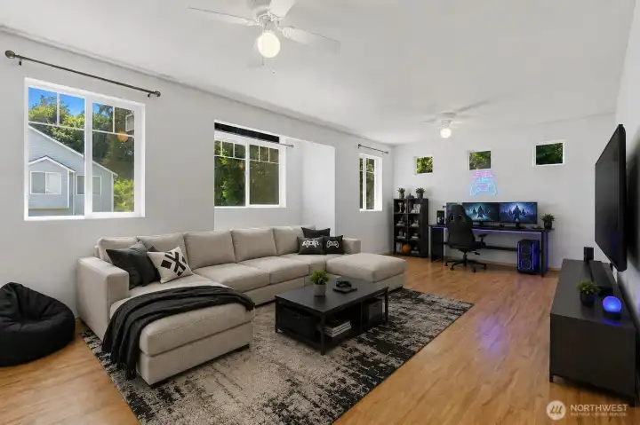 Imagine the possibilities in this expansive upper-level bonus room. Bathed in natural light from three large windows and enhanced by easy-care laminate flooring, this versatile space has been virtually staged as a media and gaming retreat. Whether you envision a craft studio, playroom, home office, teen hangout, or entertainment space, this flexible room provides the extra square footage to make it your own.