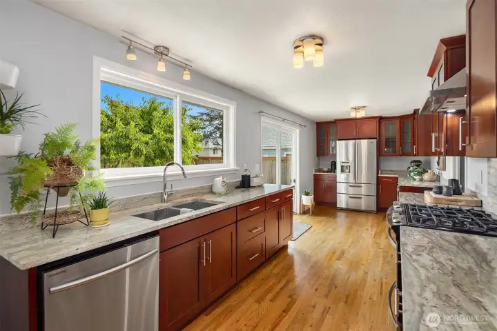 Kitchen with an abundance of counter space, gas range, stainless appliances and views over the backyard.