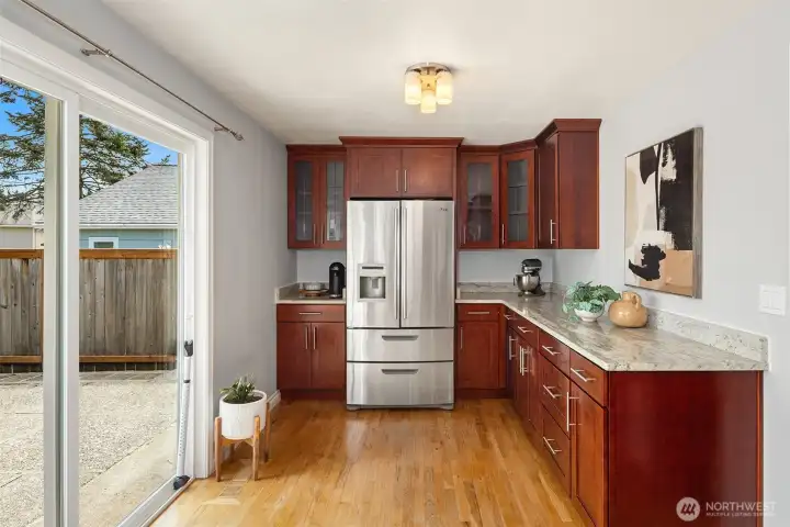 Kitchen is twice as large as expected and walks out to the back patio and an expansive backyard.