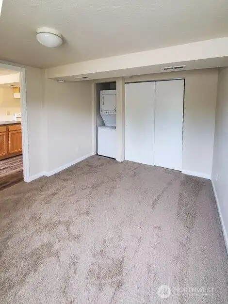 Unit B Bedroom with in unit Washer Dryer.