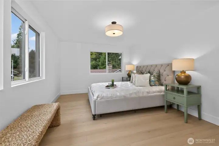 The primary suite is sunny & spacioius! Room for a king sized bed and extra furniture.